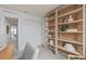 Home office featuring built-in shelving, natural light, and a view of a lake, creating a serene workspace at 10274 Hadley St, Orlando, FL 32829