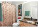 Bright bathroom featuring granite counters, a framed art piece, and a shower with decorative curtain at 10290 Cypress Vine Dr, Orlando, FL 32827