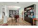 Bright room featuring a grand piano, dark wood bookcases and beautiful wood floors at 10290 Cypress Vine Dr, Orlando, FL 32827