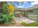 Inviting outdoor kitchen and patio with a stone bar, lush landscaping, and stylish brick pavers at 10290 Cypress Vine Dr, Orlando, FL 32827