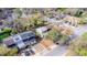 Aerial view of the property in a residential neighborhood featuring mature trees and street parking at 12240 Huntsman Ln, Orlando, FL 32826