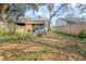 Fenced backyard featuring mature trees and a screened-in porch with outdoor seating at 12240 Huntsman Ln, Orlando, FL 32826