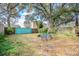 Leafy backyard with a sitting area, mature trees, and a private fence at 12240 Huntsman Ln, Orlando, FL 32826