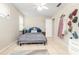 Well-lit bedroom with tiled floor, gray bed, wall decor, and ample closet space at 12240 Huntsman Ln, Orlando, FL 32826