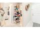 Bright hallway featuring decorative wall shelves, tiled flooring and bathroom entrance at 12240 Huntsman Ln, Orlando, FL 32826