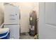 Functional laundry area with stacked washer and dryer, plus a water heater at 12240 Huntsman Ln, Orlando, FL 32826