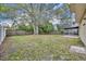 Large fenced backyard with mature tree, grass, and easy access to the screened patio at 124 Cinnamon Dr, Orlando, FL 32825