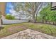 Large fenced backyard with mature tree, grass, and concrete patio at 124 Cinnamon Dr, Orlando, FL 32825