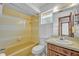 Bathroom with a bathtub, sink vanity with mirror, toilet and a small window at 124 Cinnamon Dr, Orlando, FL 32825