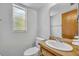 Cozy bathroom featuring a wood vanity, updated sink and toilet at 124 Cinnamon Dr, Orlando, FL 32825