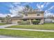 Charming two-story home featuring a brick facade, well-manicured lawn, and attached garage at 124 Cinnamon Dr, Orlando, FL 32825