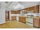 Functional kitchen featuring wooden cabinets, laminate countertops, and linoleum flooring at 124 Cinnamon Dr, Orlando, FL 32825