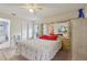 Bright bedroom with a large mirror behind bed, neutral carpet, and ceiling fan at 13469 Texas Woods Cir, Orlando, FL 32824