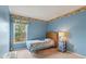 Well-lit bedroom with a large window, patterned wallpaper border, and natural light at 13469 Texas Woods Cir, Orlando, FL 32824