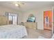 Bright bedroom featuring sliding glass door, neutral carpet, and ceiling fan at 13469 Texas Woods Cir, Orlando, FL 32824