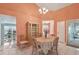 Elegant dining area with a chandelier and views into the adjacent living spaces at 13469 Texas Woods Cir, Orlando, FL 32824