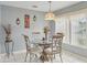 Dining area with a chandelier, large window, and neutral paint at 13469 Texas Woods Cir, Orlando, FL 32824