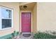 Close-up of the red front door with a welcoming doormat and a well-kept exterior at 13469 Texas Woods Cir, Orlando, FL 32824