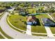 Aerial view of a single-Gathering home with lush green lawns and mature trees in a residential neighborhood at 1727 Garden View St, Mascotte, FL 34753