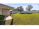 Spacious backyard featuring lush green grass, a white fence, and well-maintained landscaping at 1727 Garden View St, Mascotte, FL 34753