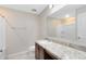 Bathroom with a marble countertop vanity and shower-tub combo at 1727 Garden View St, Mascotte, FL 34753