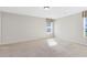 Bedroom with carpeted floors and natural light streaming through windows at 1727 Garden View St, Mascotte, FL 34753