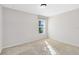 Bright bedroom featuring carpeted floors and natural light from the window at 1727 Garden View St, Mascotte, FL 34753