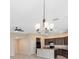 Open living area with stylish light fixture, ceiling fan, and modern kitchen at 1727 Garden View St, Mascotte, FL 34753