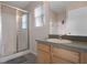 Bright bathroom featuring a glass-enclosed shower, light wood vanity, and natural light at 176 Blue Jay Way, Davenport, FL 33896