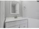 Neutral bathroom featuring a white vanity and mirror, offering a simple and clean space at 176 Blue Jay Way, Davenport, FL 33896