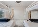 Clean bedroom featuring two sets of bunk beds with ladders, neutral carpeting, and a door to a walk-in closet at 176 Blue Jay Way, Davenport, FL 33896