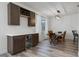 Dining area with built-in bar, wine rack, quartz countertops, and stainless steel wine fridge at 176 Blue Jay Way, Davenport, FL 33896