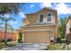 Two-story home featuring an attached two-car garage, well-maintained lawn and simple landscaping at 176 Blue Jay Way, Davenport, FL 33896