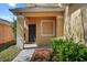 Inviting front porch with manicured shrubs and mulch bed offering curb appeal at 176 Blue Jay Way, Davenport, FL 33896