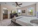 Comfortable main bedroom featuring a modern ceiling fan and in-room fireplace and TV at 176 Blue Jay Way, Davenport, FL 33896