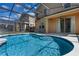 Sparkling pool area featuring screened-in enclosure and seamless access to the home's outdoor living space at 176 Blue Jay Way, Davenport, FL 33896