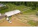 Aerial shot of horse farm with fenced paddocks, barn, and truck with trailer at 2166 Woodbridge Rd, Longwood, FL 32779