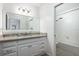 Bright bathroom featuring granite counters, a shower with a tub, and a large, framed mirror at 2166 Woodbridge Rd, Longwood, FL 32779