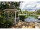 Elegant gazebo situated next to the serene lake with lush tropical surroundings at 2166 Woodbridge Rd, Longwood, FL 32779