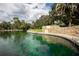 Beautiful lake with a stone retaining wall and clear water for swimming at 2166 Woodbridge Rd, Longwood, FL 32779