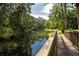 Picturesque pond reflecting the surrounding trees, accessible by a wooden bridge at 2166 Woodbridge Rd, Longwood, FL 32779