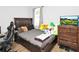 Bedroom featuring a dark wood bed frame, TV, and laminate wood flooring at 2168 Continental St, St Cloud, FL 34769