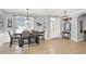 Inviting dining area leading into the home's entryway with neutral tile flooring and a view to the front door at 2168 Continental St, St Cloud, FL 34769