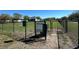 Fenced dog park entrance with posted policies and waste disposal, providing a secure area for pets at 2168 Continental St, St Cloud, FL 34769