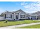 Charming single-story home features a manicured lawn, two-car garage, and welcoming front entrance with decorative accents at 2168 Continental St, St Cloud, FL 34769