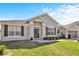 Charming single-story home features a well-manicured lawn, and a welcoming front entrance with a decorative wreath at 2168 Continental St, St Cloud, FL 34769