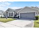 This gray home features a two car garage and well-maintained landscaping, offering both convenience and curb appeal at 2168 Continental St, St Cloud, FL 34769