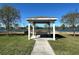 Scenic gazebo with a bench overlooking the serene pond, perfect for relaxation and enjoying nature at 2168 Continental St, St Cloud, FL 34769