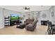 Inviting living room with tiled floors, ceiling fan, fireplace, and an open layout into the kitchen at 2168 Continental St, St Cloud, FL 34769