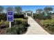 Inviting community entrance at Sunset Park featuring manicured landscaping, a gazebo, and accessible walking paths at 2168 Continental St, St Cloud, FL 34769